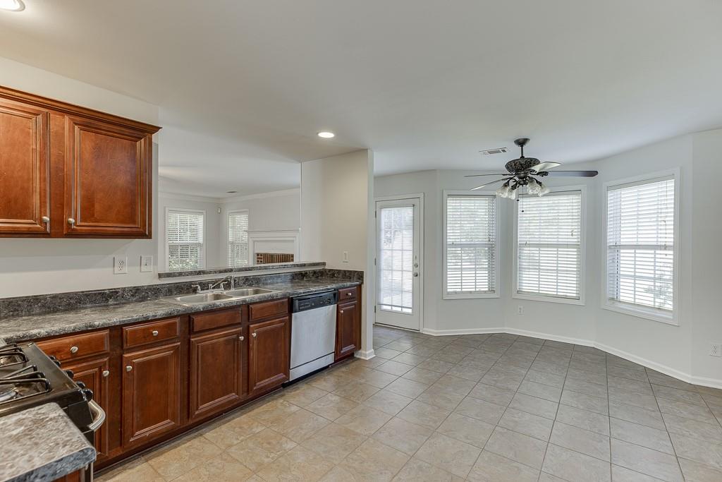 926 Red Wolf Court Dacula, GA 30019 - Photo 19 of 47 a large kitchen with stainless steel appliances granite countertop a stove a sink and a granite counter tops
