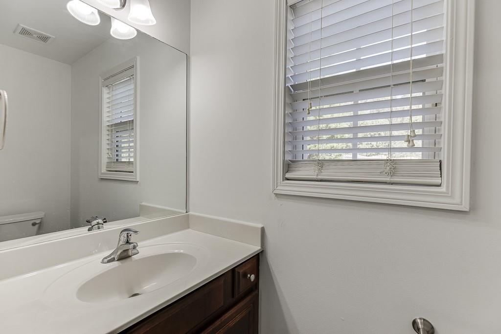 926 Red Wolf Court Dacula, GA 30019 - Photo 20 of 47 a bathroom with a sink and a mirror
