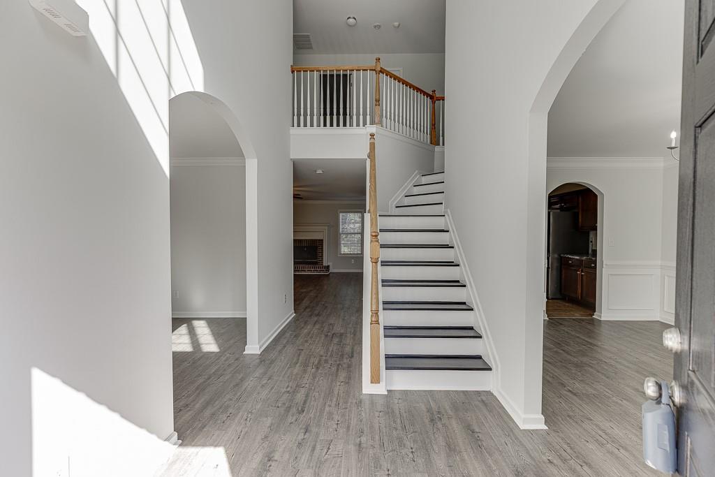926 Red Wolf Court Dacula, GA 30019 - Photo 2 of 47 a view of a hallway with wooden floor and entryway