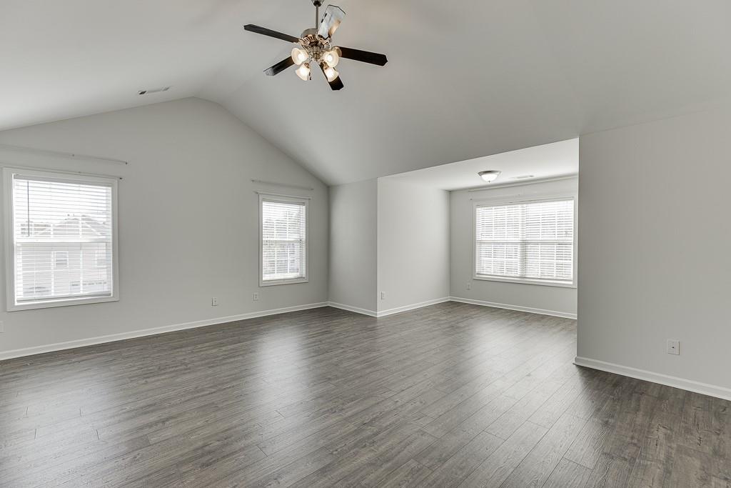 926 Red Wolf Court Dacula, GA 30019 - Photo 22 of 47 an empty room with wooden floor fan and windows