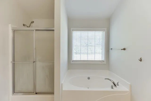 a white bath tub sitting next to a window