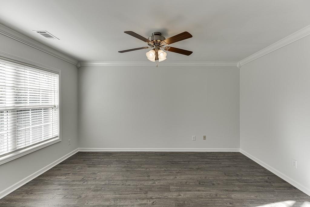 926 Red Wolf Court Dacula, GA 30019 - Photo 3 of 47 a view of empty room with wooden floor and fan