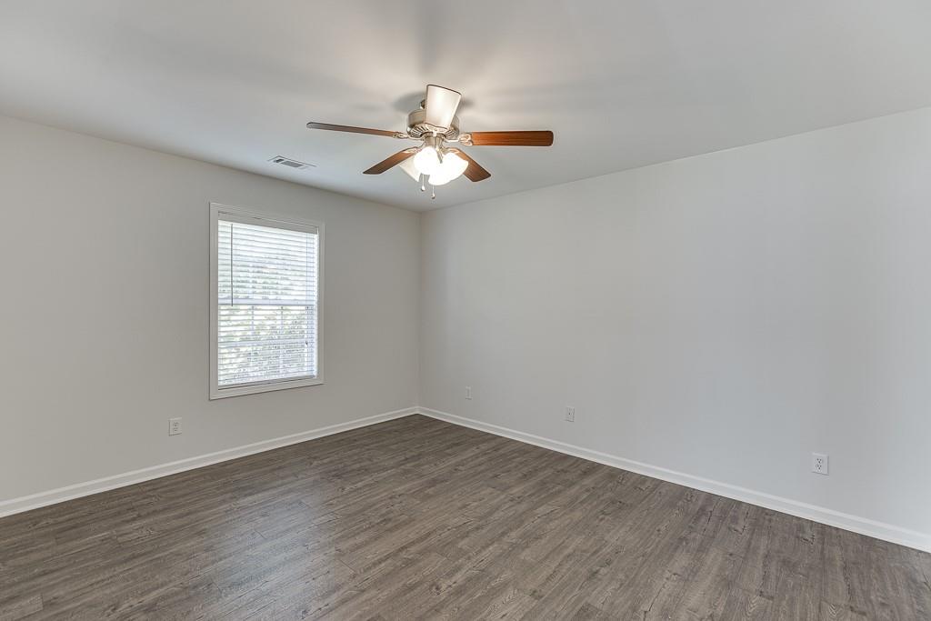 926 Red Wolf Court Dacula, GA 30019 - Photo 32 of 47 an empty room with wooden floor fan and windows