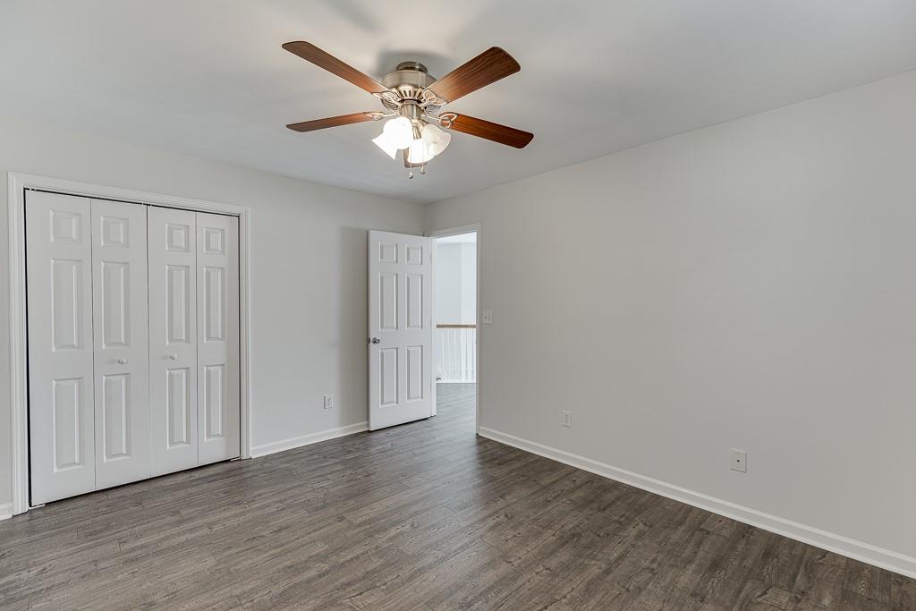 926 Red Wolf Court Dacula, GA 30019 - Photo 33 of 47 an empty room with wooden floor and windows