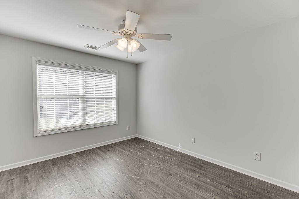 926 Red Wolf Court Dacula, GA 30019 - Photo 34 of 47 an empty room with wooden floor and windows