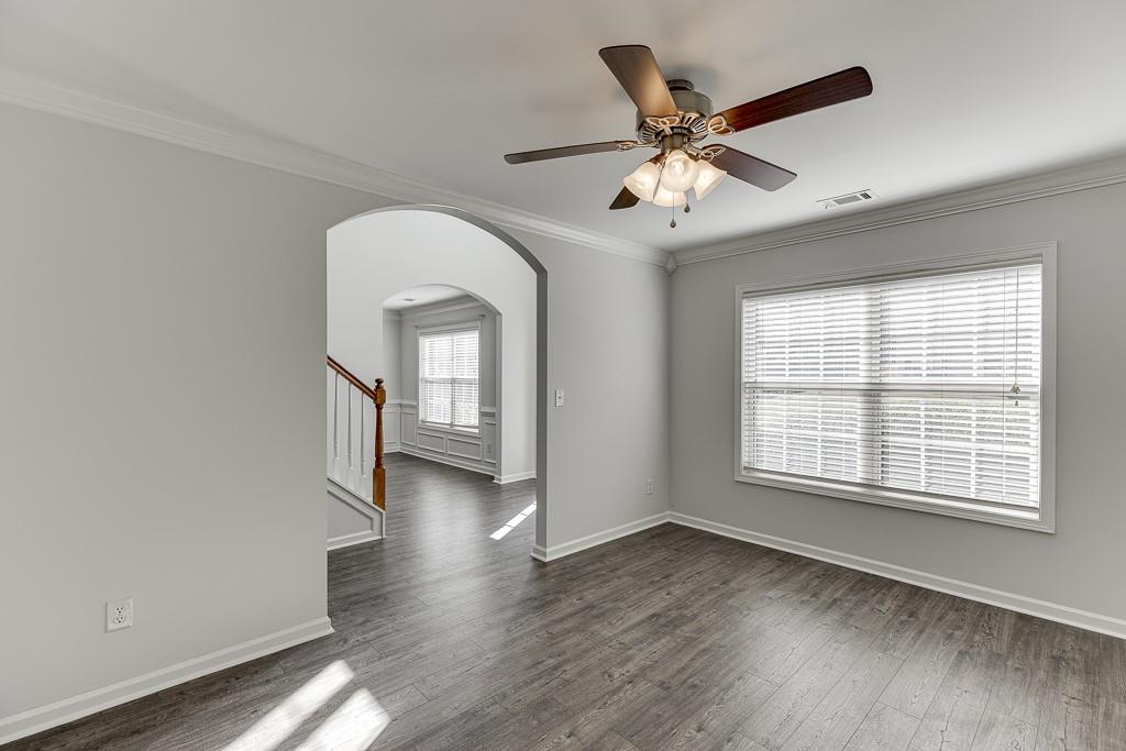926 Red Wolf Court Dacula, GA 30019 - Photo 4 of 47 a view of a livingroom with a ceiling fan and wooden floor