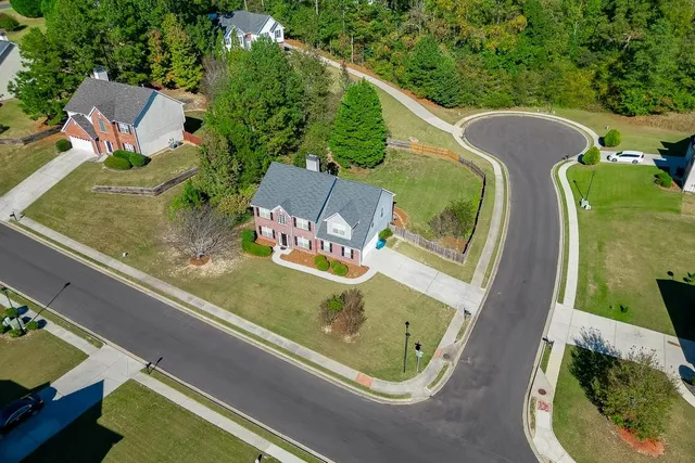 an aerial view of a residential houses with outdoor space