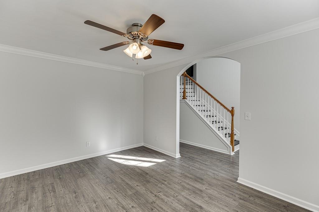 926 Red Wolf Court Dacula, GA 30019 - Photo 5 of 47 an empty room with wooden floor fan and windows