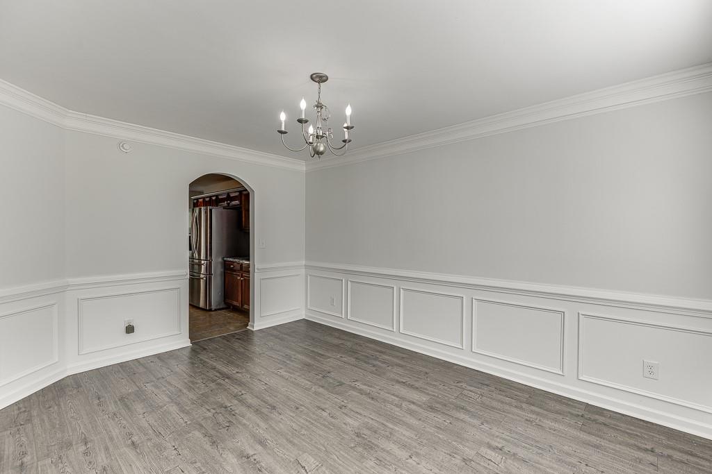 926 Red Wolf Court Dacula, GA 30019 - Photo 8 of 47 wooden floor in an empty room with a window