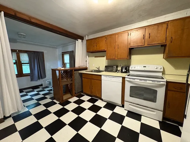 a kitchen with a stove a sink and a cabinets