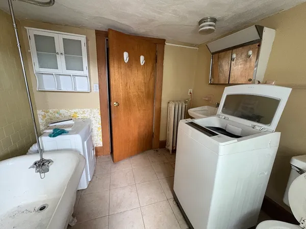 a bathroom with a sink toilet and tub