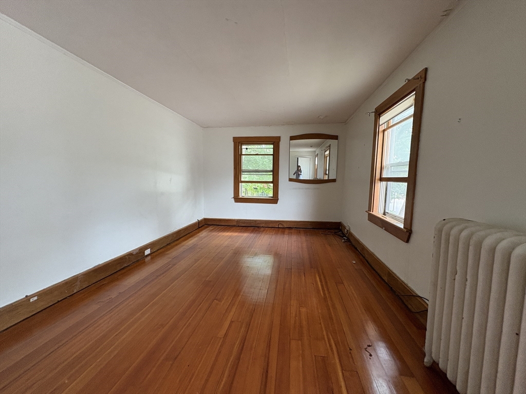 28 Woodward Street, Unit 2 Newton, MA 02461 - Photo 4 of 20 an empty room with wooden floor and windows