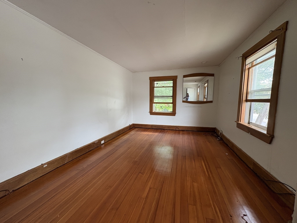 28 Woodward Street, Unit 2 Newton, MA 02461 - Photo 5 of 20 an empty room with wooden floor and windows