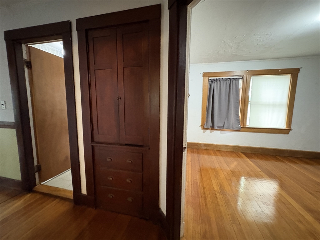 28 Woodward Street, Unit 2 Newton, MA 02461 - Photo 6 of 20 an empty room with wooden floor and a window