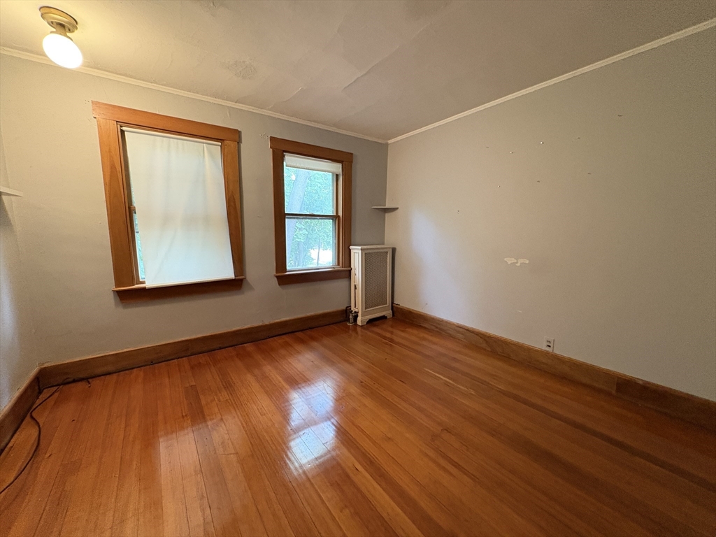 28 Woodward Street, Unit 2 Newton, MA 02461 - Photo 7 of 20 an empty room with wooden floor and windows