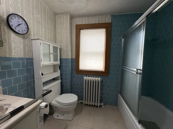 a bathroom with a toilet a sink and a shower