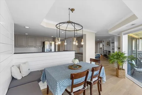 a view of a dining room with furniture and chandelier