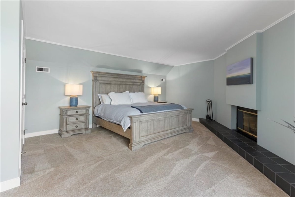 29 Ladds Way, Unit 29 Scituate, MA 02066 - Photo 22 of 33 a bedroom with a bed and a fireplace