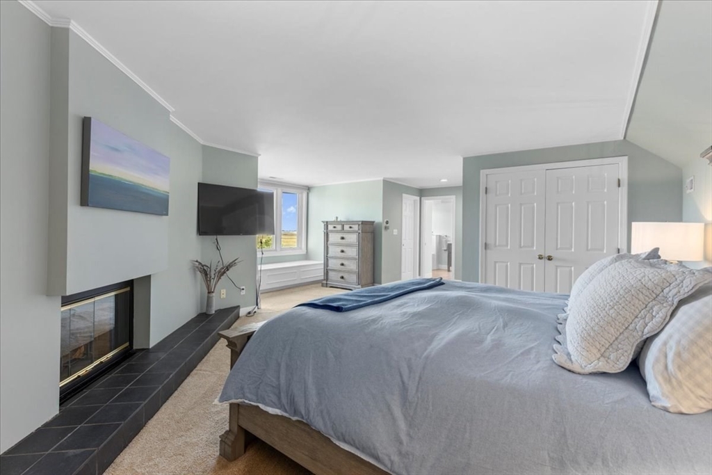 29 Ladds Way, Unit 29 Scituate, MA 02066 - Photo 24 of 33 a spacious bedroom with a bed and a flat screen tv