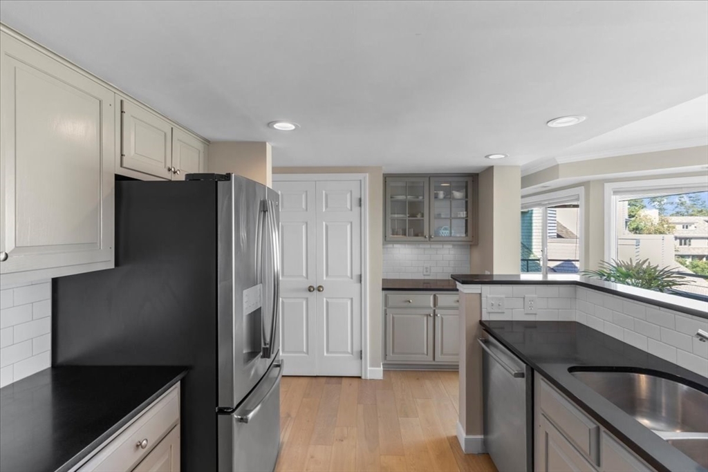29 Ladds Way, Unit 29 Scituate, MA 02066 - Photo 4 of 33 a kitchen with stainless steel appliances granite countertop a refrigerator and a sink