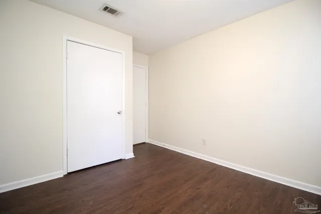 an empty room with wooden floor