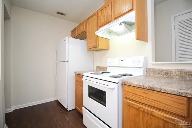 a kitchen with a stove a sink and a refrigerator