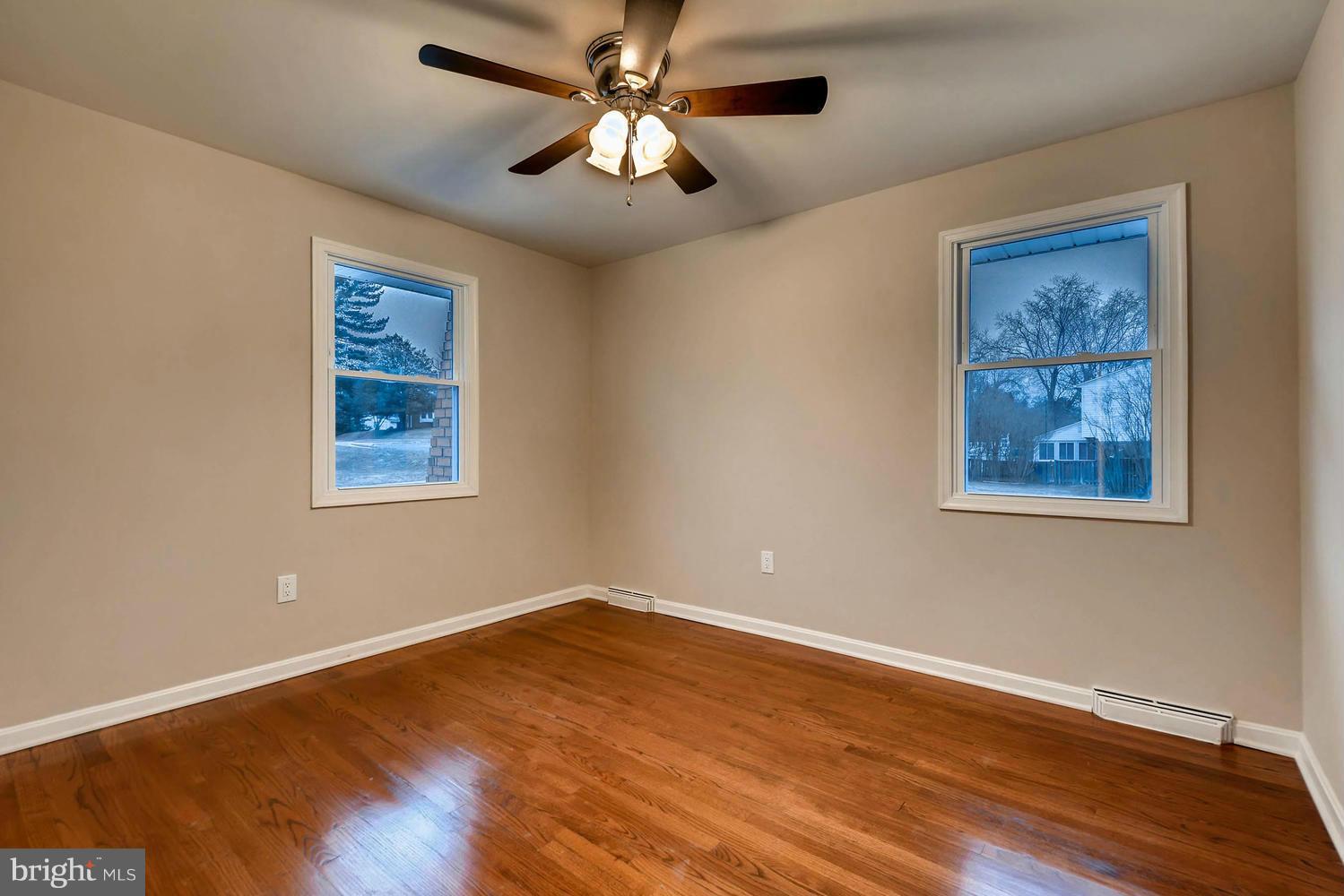 4515 Tapscott Road Pikesville, MD 21208 - Photo 18 of 28 a view of a big room with wooden floor and windows