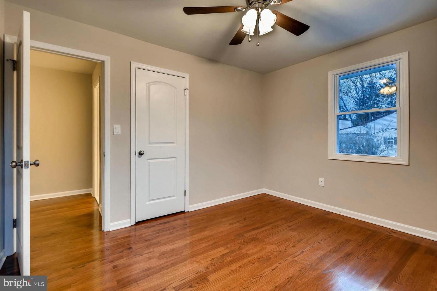 4515 Tapscott Road Pikesville, MD 21208 - Photo 19 of 28 wooden floor in an empty room with a window