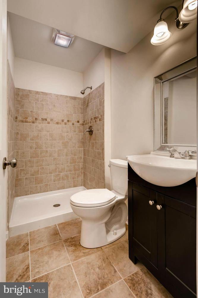 4515 Tapscott Road Pikesville, MD 21208 - Photo 24 of 28 a bathroom with a sink toilet and shower