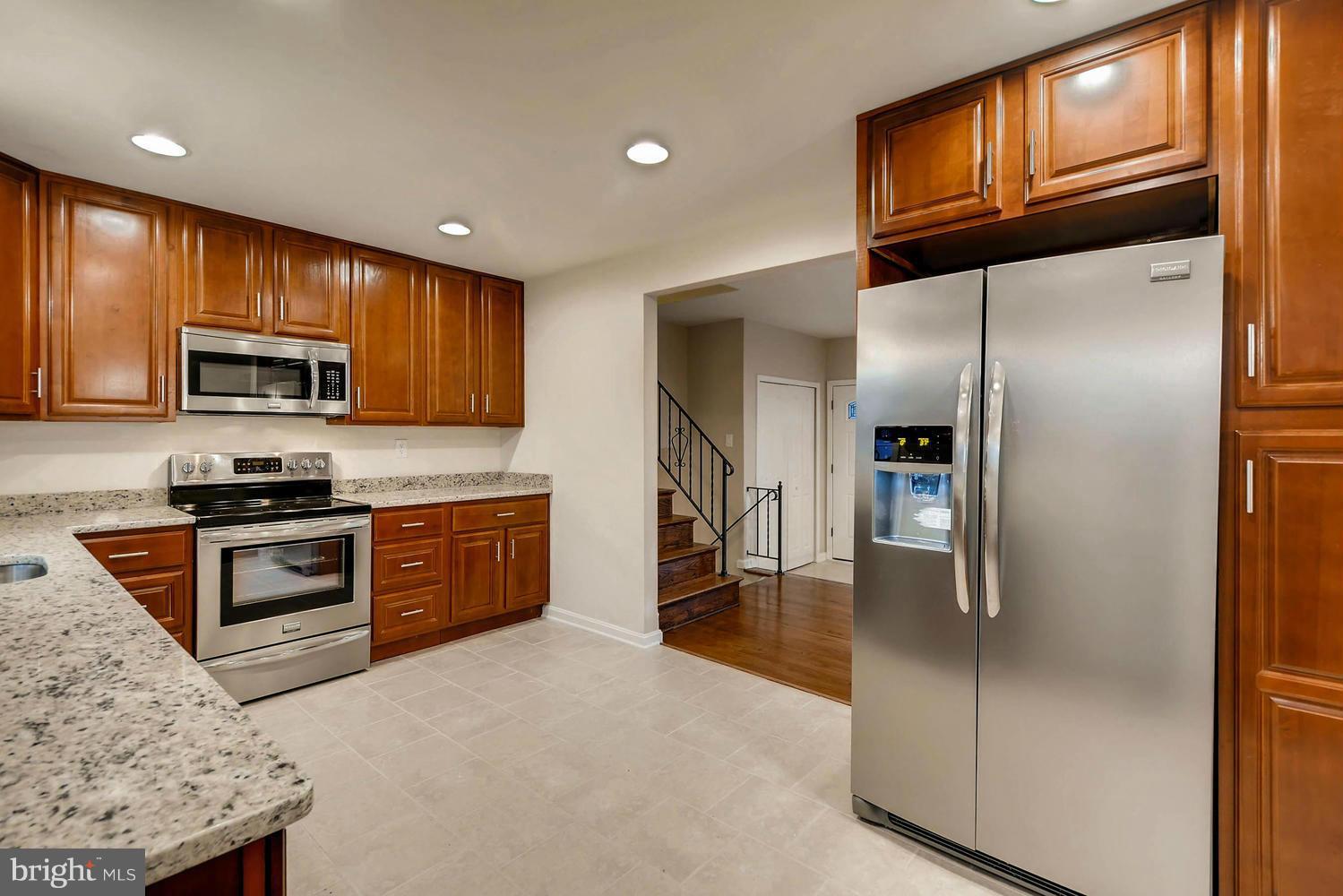 4515 Tapscott Road Pikesville, MD 21208 - Photo 6 of 28 a kitchen with stainless steel appliances granite countertop a refrigerator a stove top oven a sink and dishwasher