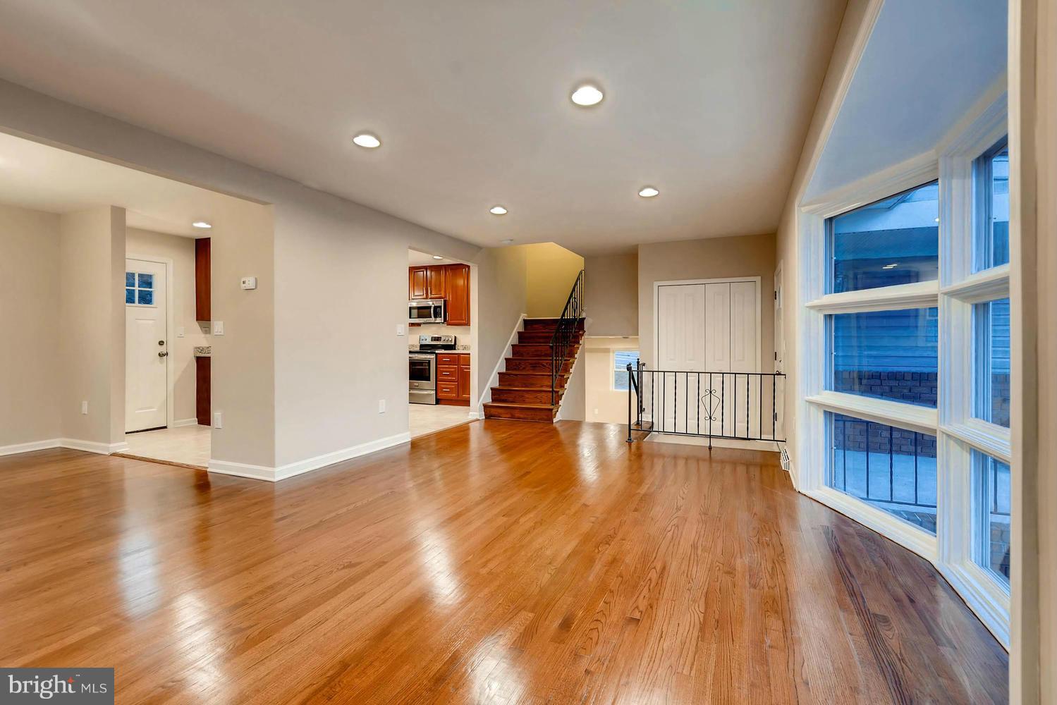 4515 Tapscott Road Pikesville, MD 21208 - Photo 9 of 28 a view of a living room with wooden floor and a large window