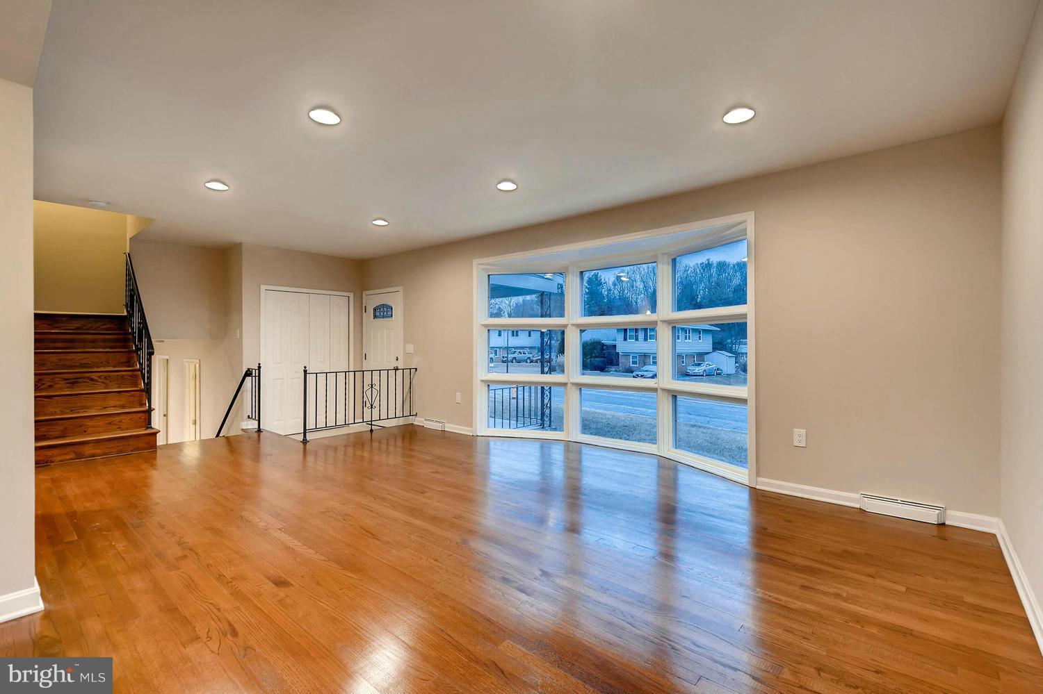 4515 Tapscott Road Pikesville, MD 21208 - Photo 10 of 28 a view of an empty room with wooden floor and a window