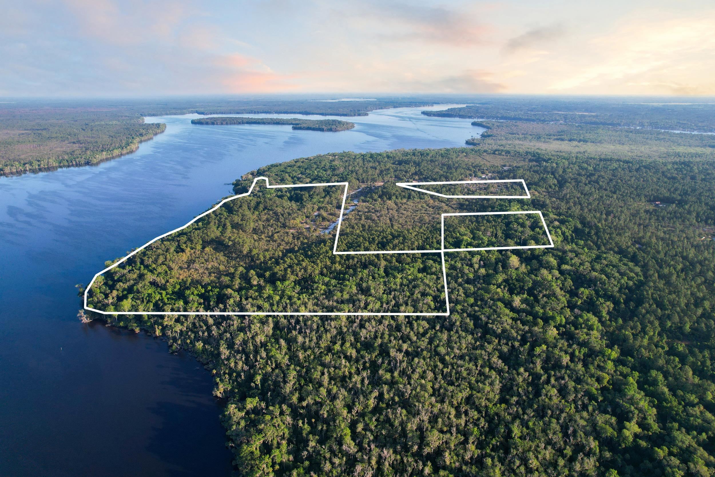 356 Drayton Island Road Georgetown, FL 32139 - Photo 14 of 41 a view of a large building with a field