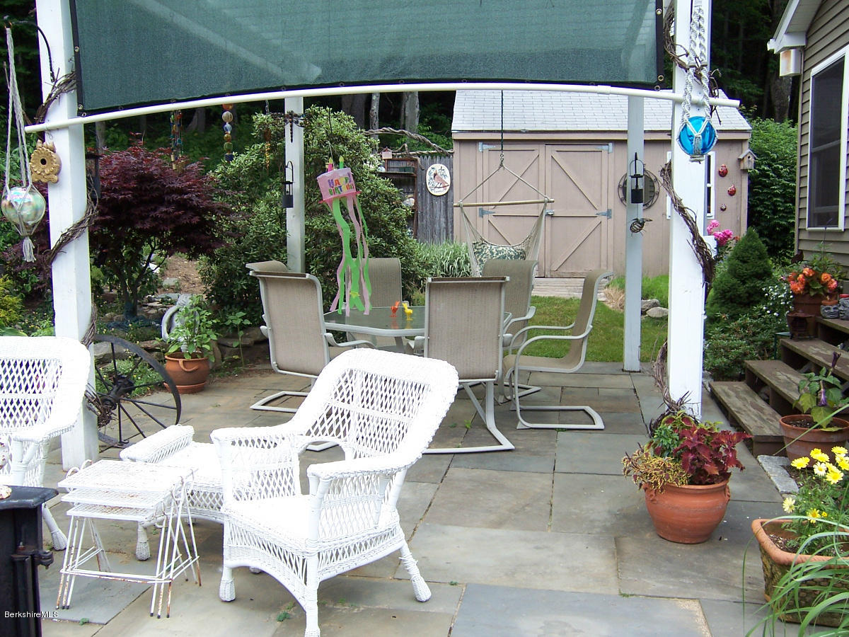 44 Stonehouse Road Washington, MA 01223 - Photo 16 of 56 a view of a patio with table and chairs potted plants