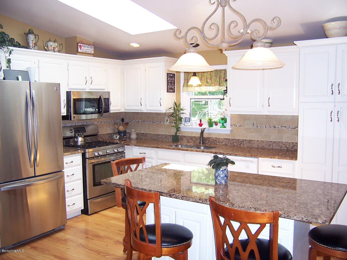 44 Stonehouse Road Washington, MA 01223 - Photo 31 of 56 a kitchen with stainless steel appliances granite countertop a sink refrigerator stove and microwave