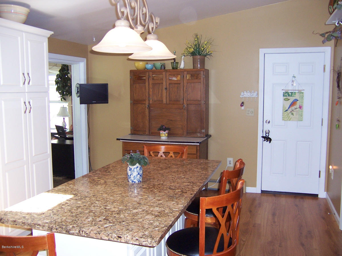 44 Stonehouse Road Washington, MA 01223 - Photo 32 of 56 a dining room with table chairs and kitchen view