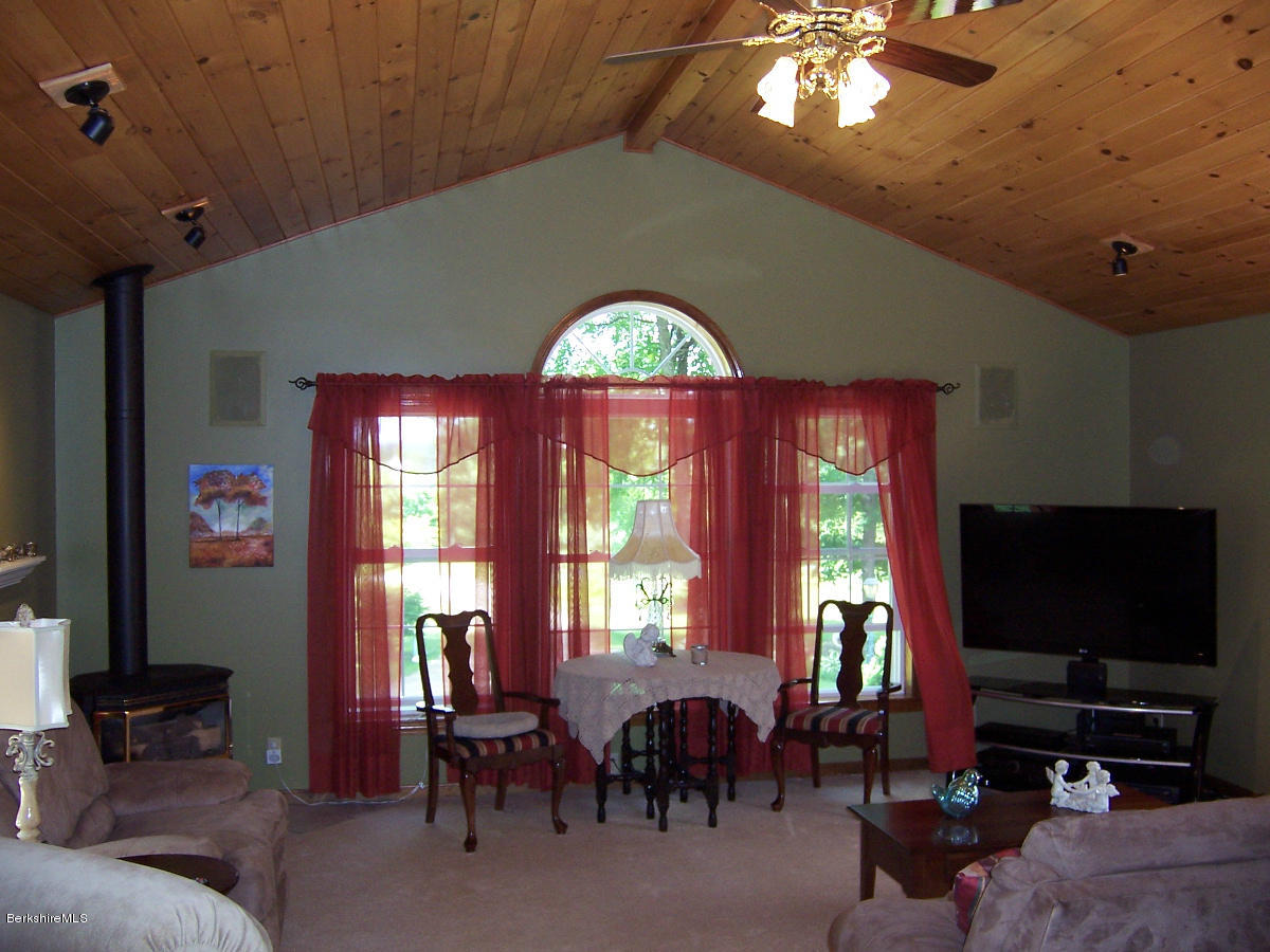 44 Stonehouse Road Washington, MA 01223 - Photo 40 of 56 a living room with furniture a large window and a flat screen tv