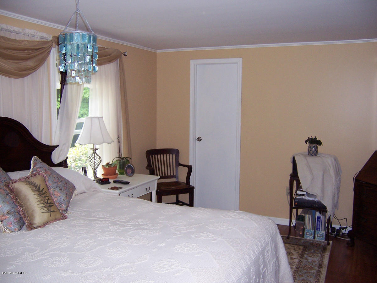 44 Stonehouse Road Washington, MA 01223 - Photo 44 of 56 a bedroom with furniture and a chandelier