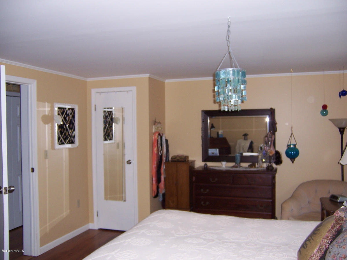 44 Stonehouse Road Washington, MA 01223 - Photo 45 of 56 a room with a chandelier and a dresser