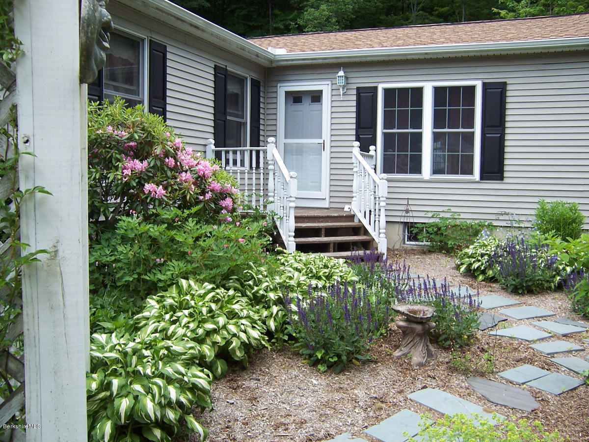 44 Stonehouse Road Washington, MA 01223 - Photo 10 of 56 a view of a house that has a flower garden