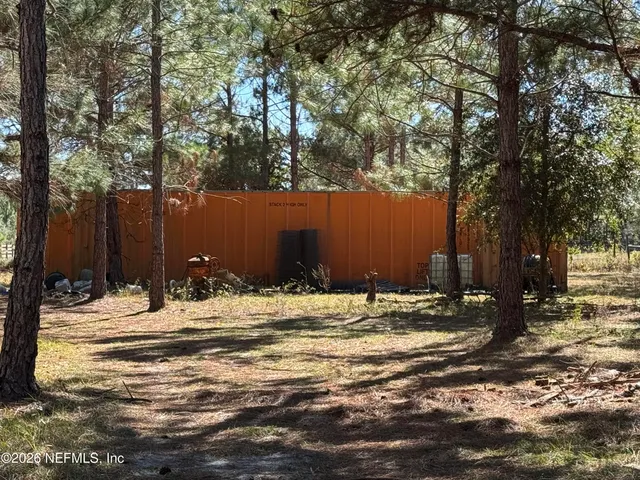 a view of a tree with a yard