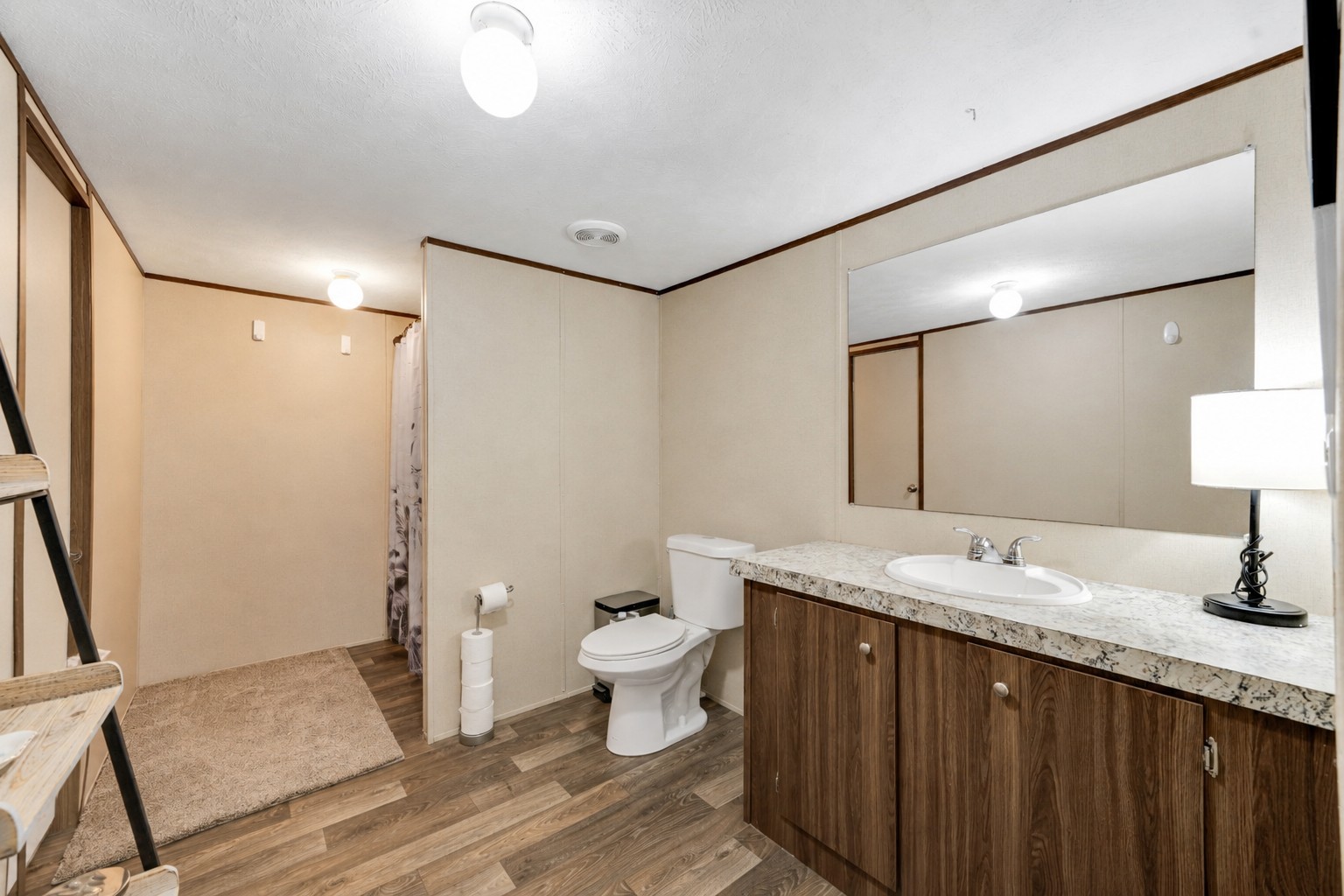 2755 Washburn Road Luling, TX 78648 - Photo 15 of 40 Functional bathroom featuring a walk-in closet, tub/shower combo and a vanity with ample storage.