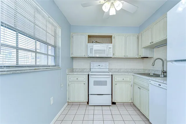 a kitchen with a stove sink and cabinets