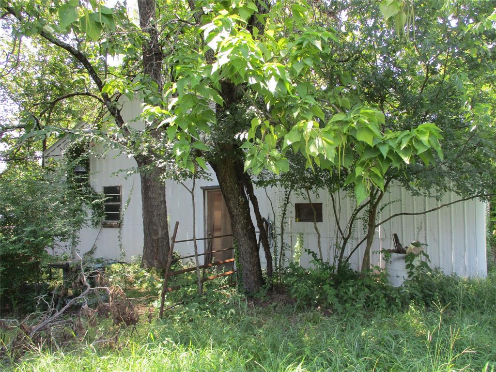 Tbd Wood Street Emory, TX 75440 - Photo 2 of 9 a backyard of a house with plants and large tree