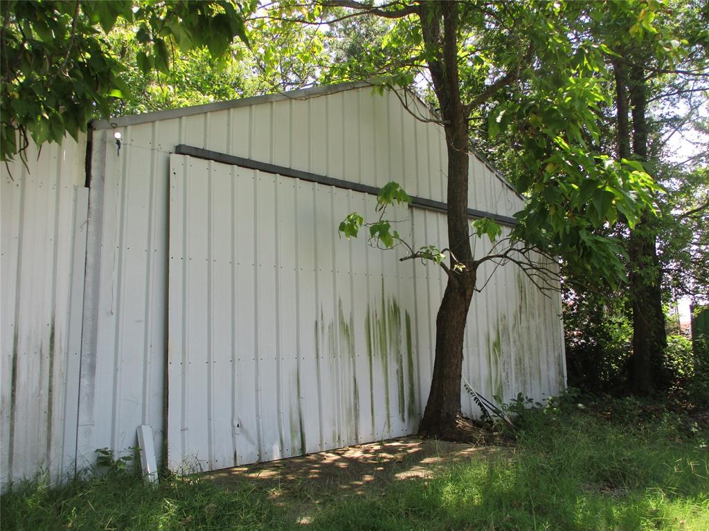 Tbd Wood Street Emory, TX 75440 - Photo 8 of 9 a view of a backyard with plants and a large tree