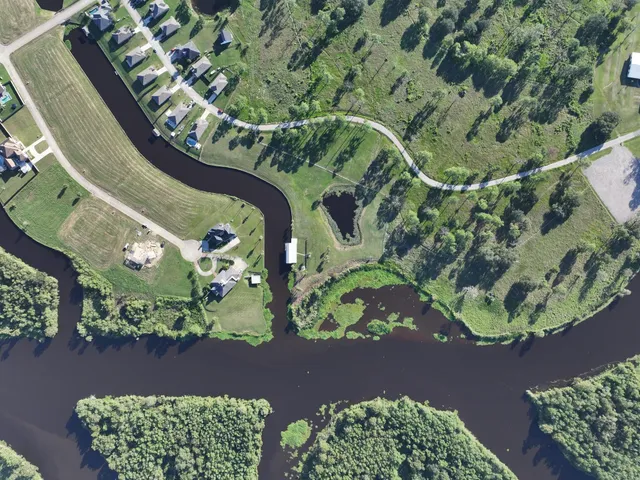 an aerial view of a house with a lake view
