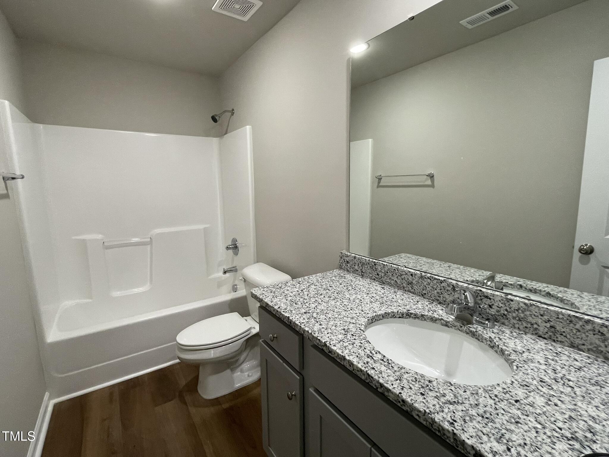 181 Pate Landing Drive Selma, NC 27576 - Photo 11 of 15 a bathroom with a granite countertop sink a toilet and shower