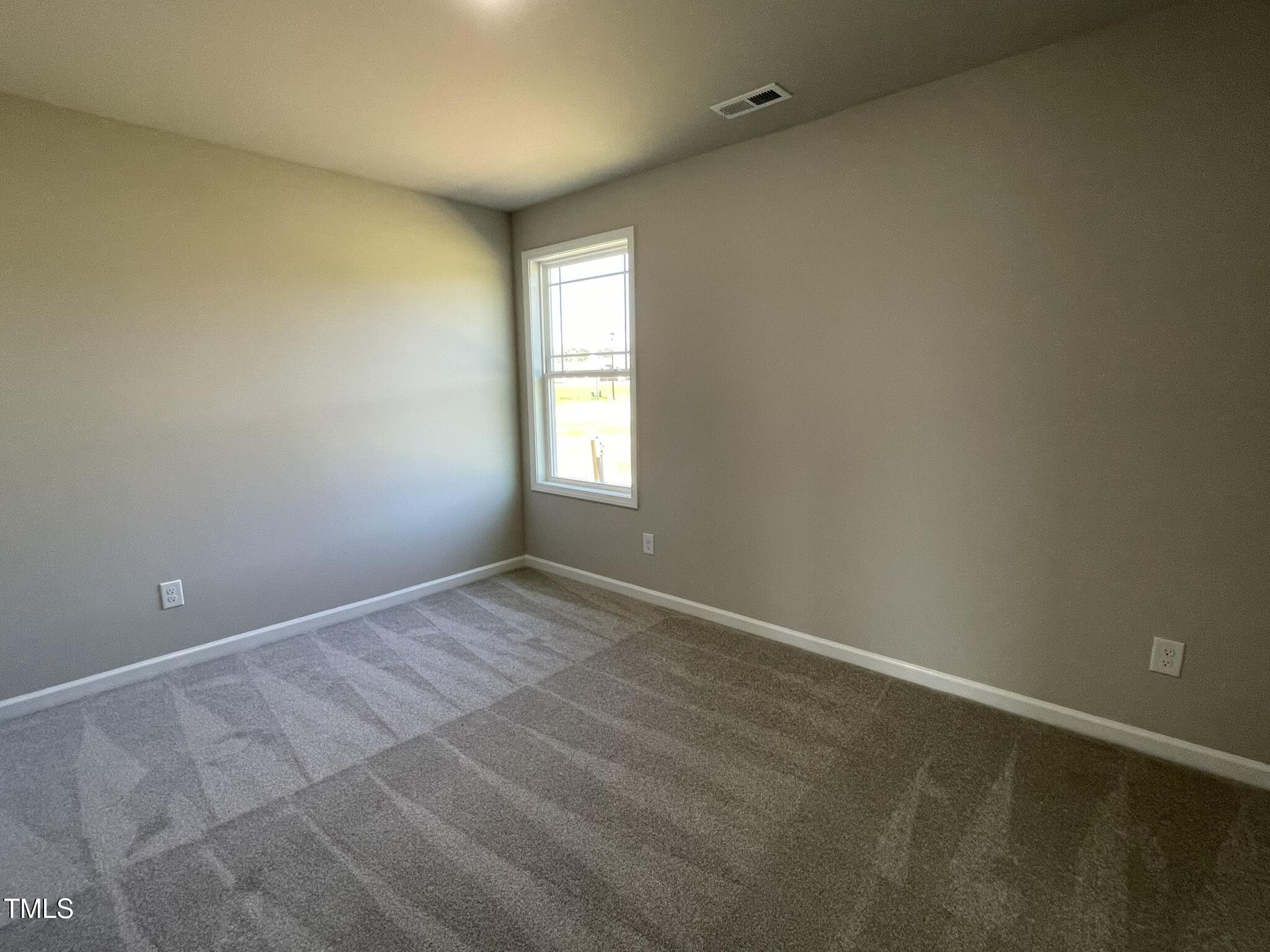 181 Pate Landing Drive Selma, NC 27576 - Photo 12 of 15 a view of an empty room and window