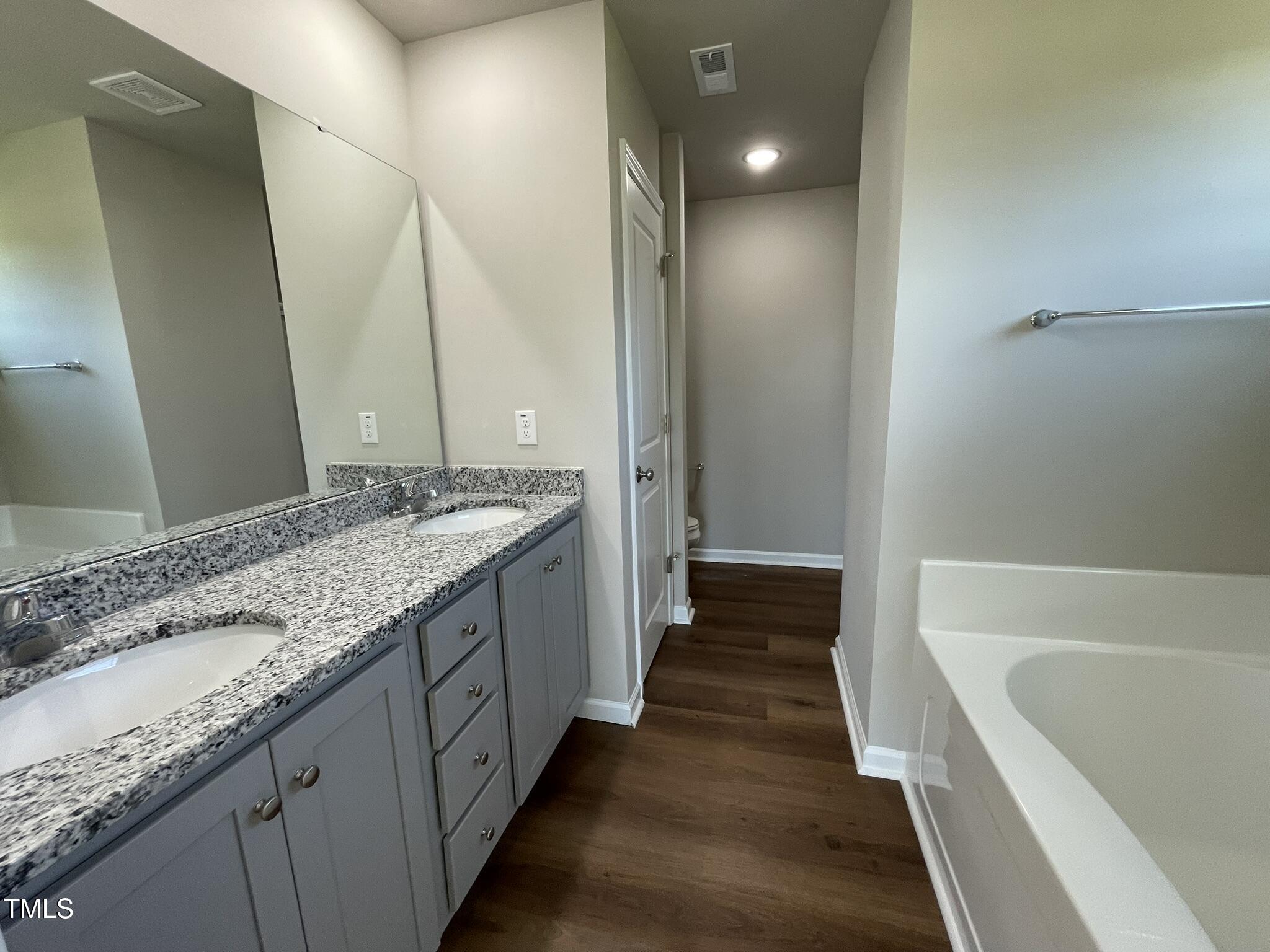181 Pate Landing Drive Selma, NC 27576 - Photo 8 of 15 a bathroom with a granite countertop double vanity sink and a large mirror