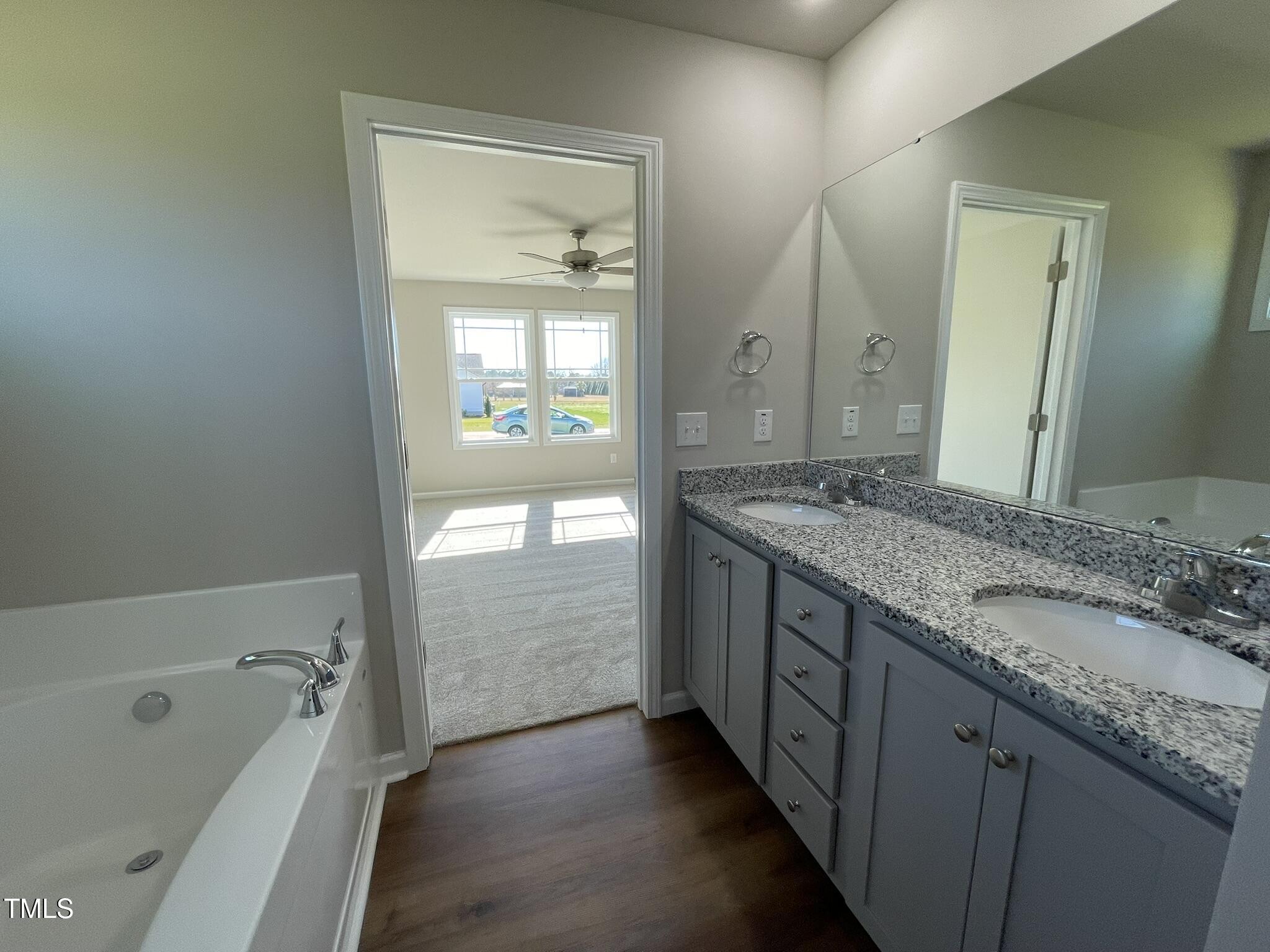 181 Pate Landing Drive Selma, NC 27576 - Photo 9 of 15 a bathroom with a granite countertop sink mirror and a bathtub